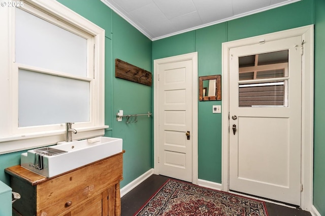 interior space featuring vanity, baseboards, and ornamental molding