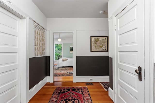 hall with wood finished floors and baseboards