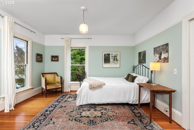 bedroom with wood finished floors and baseboards