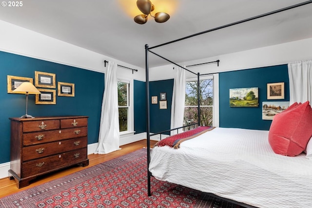 bedroom featuring baseboards and wood finished floors