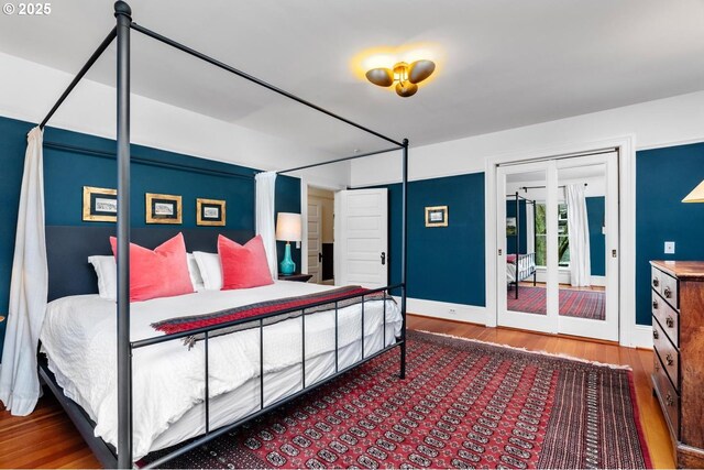 bedroom featuring wood finished floors and baseboards