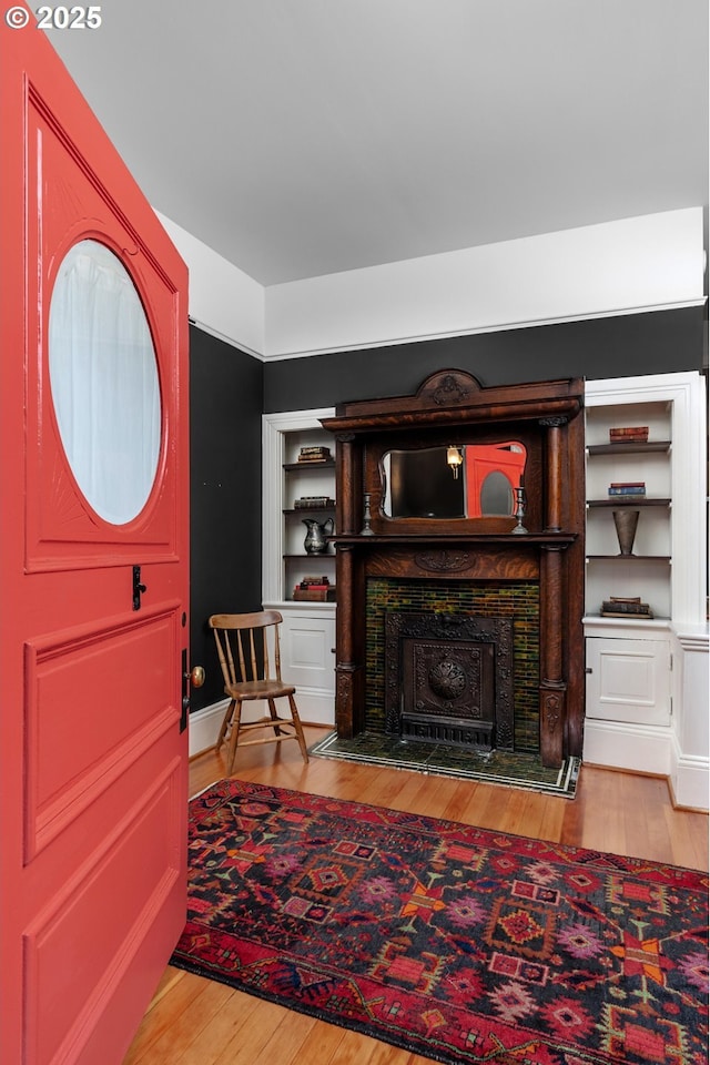 foyer featuring a fireplace and wood finished floors