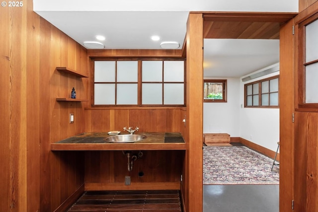 office featuring a sink, baseboards, and wet bar