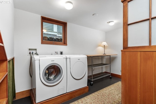 laundry room with washing machine and clothes dryer, laundry area, and baseboards