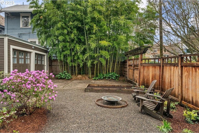 view of yard with a garage and a fenced backyard