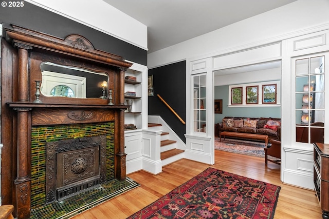 living area featuring light wood finished floors and stairway