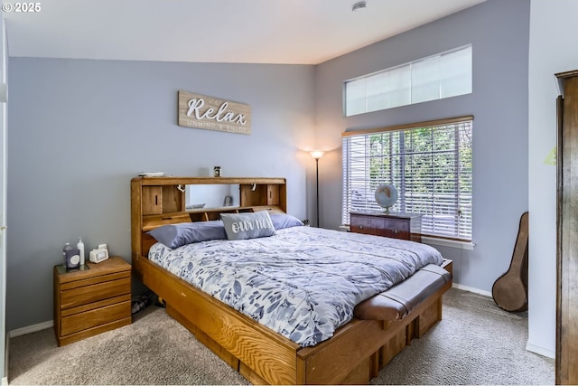 carpeted bedroom featuring baseboards