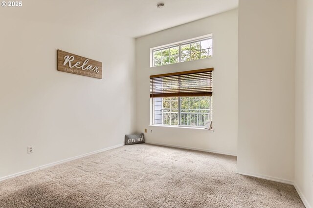 17532 NW Springville Rd Unit D8, Portland, OR 97229 - spare room featuring carpet floors, healthy amount of natural light, and a smoke detector