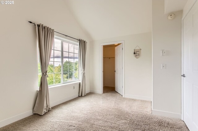17532 NW Springville Rd Unit D8, Portland, OR 97229 - unfurnished bedroom featuring light carpet, lofted ceiling, and a closet