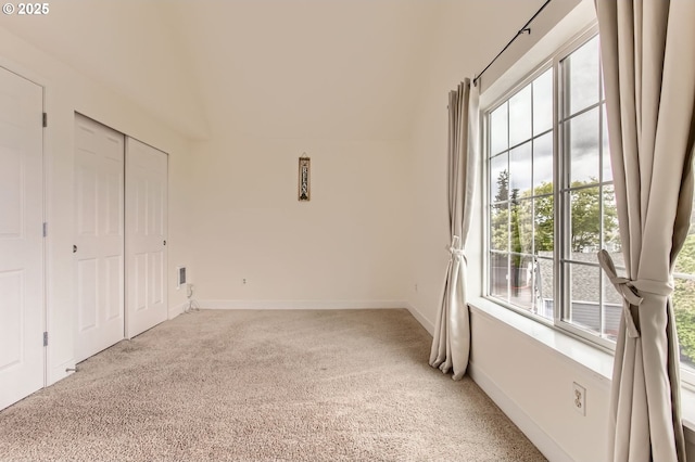 17532 NW Springville Rd Unit D8, Portland, OR 97229 - unfurnished bedroom with multiple windows, light carpet, and a closet