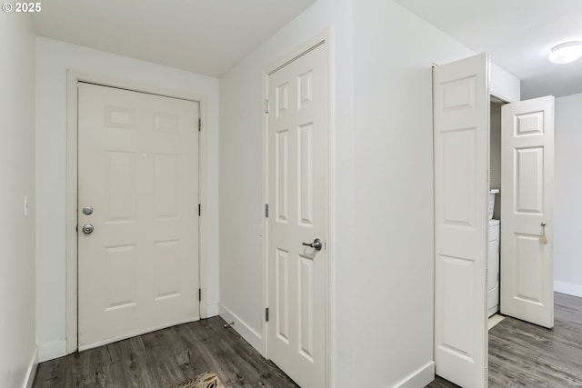foyer with baseboards, washer / dryer, and wood finished floors