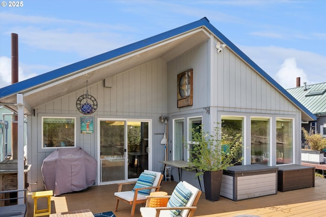 back of property featuring a wooden deck