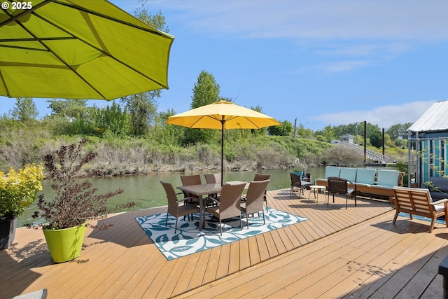 wooden terrace featuring an outdoor hangout area, outdoor dining area, and a water view