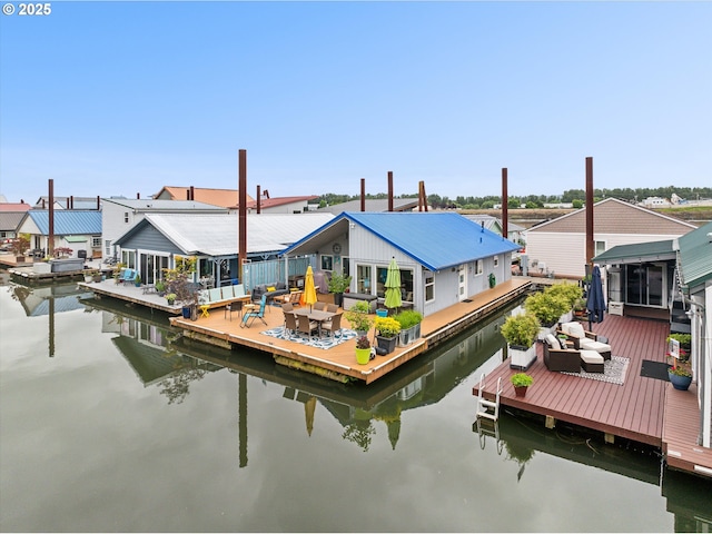view of dock with a deck with water view and a residential view