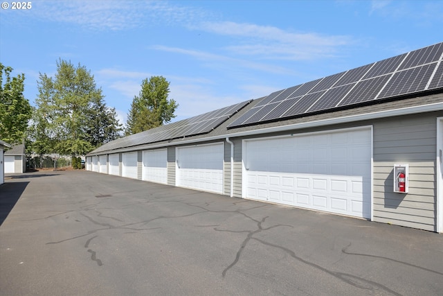 garage featuring roof mounted solar panels