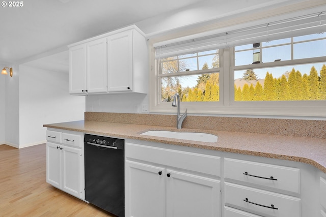 kitchen featuring light wood-type flooring, dishwasher, sink, and white cabinets