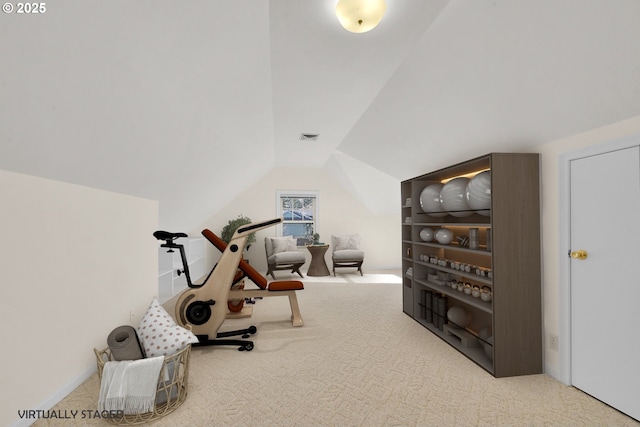 exercise room with vaulted ceiling and carpet floors