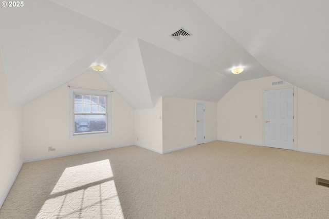 bonus room featuring lofted ceiling and light colored carpet