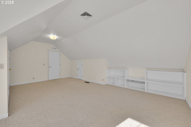 bonus room featuring vaulted ceiling and light carpet