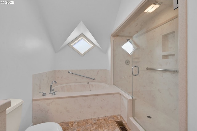 bathroom featuring shower with separate bathtub, a wealth of natural light, and toilet