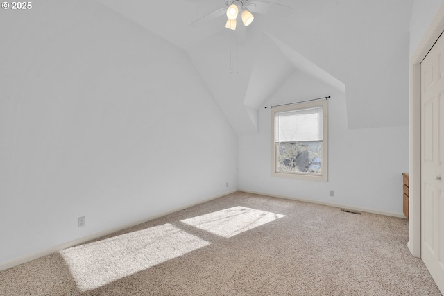 bonus room with ceiling fan, light colored carpet, and vaulted ceiling