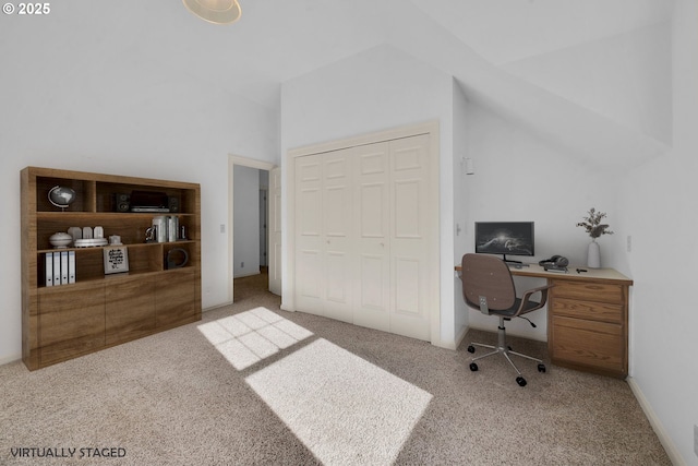 office space with vaulted ceiling and light colored carpet