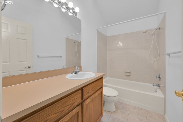 full bathroom with tile patterned flooring, vanity, tiled shower / bath combo, and toilet