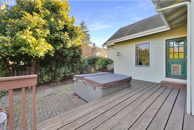 deck with a covered hot tub