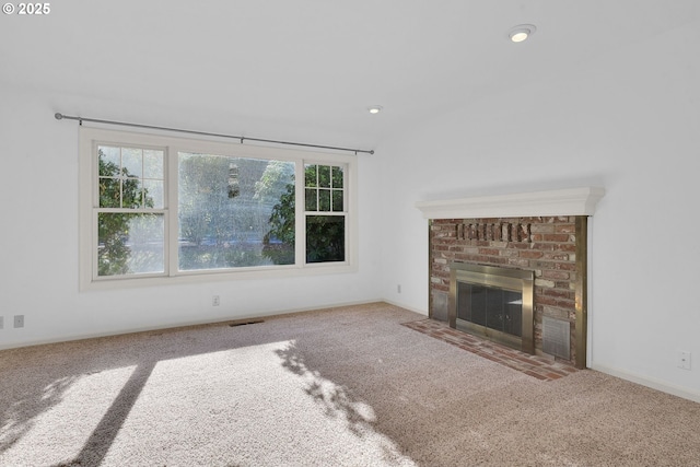 unfurnished living room with a fireplace and carpet floors