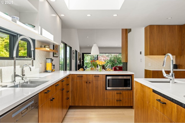 2930 NW Quimby St, Portland, OR 97210 - kitchen with stainless steel appliances, a sink, a skylight, and recessed lighting