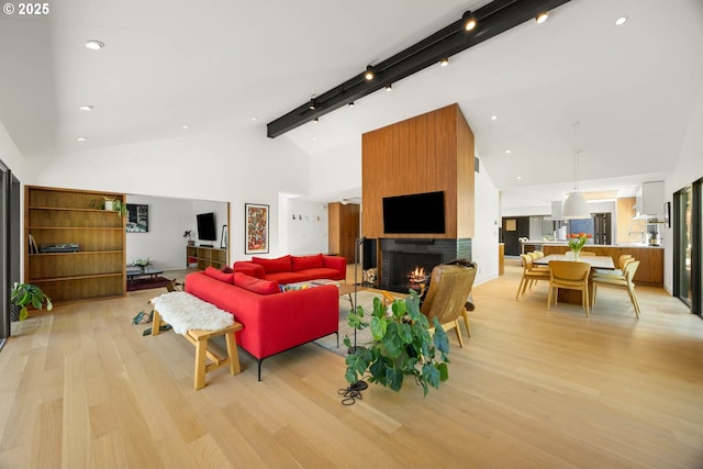 2930 NW Quimby St, Portland, OR 97210 - living area featuring light wood-style floors, a large fireplace, high vaulted ceiling, track lighting, and beamed ceiling
