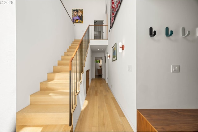 2930 NW Quimby St, Portland, OR 97210 - staircase with wood finished floors and a towering ceiling