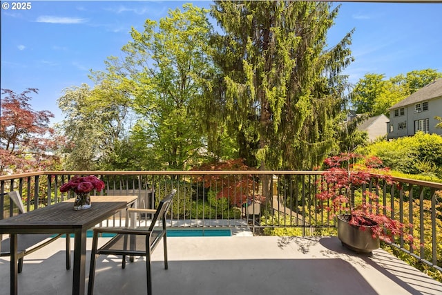 2930 NW Quimby St, Portland, OR 97210 - balcony featuring view of pool, outdoor dining space, and a patio area