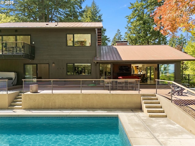 2930 NW Quimby St, Portland, OR 97210 - rear view of house with a balcony, an outdoor pool, metal roof, and a patio area