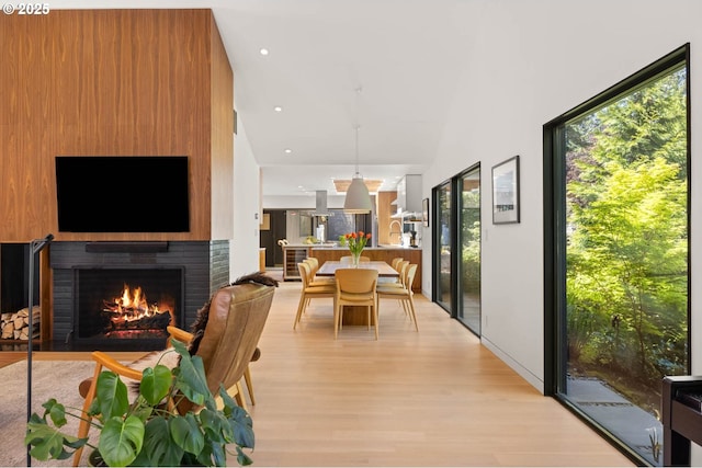 2930 NW Quimby St, Portland, OR 97210 - dining space featuring light wood-style flooring, a fireplace, plenty of natural light, and recessed lighting