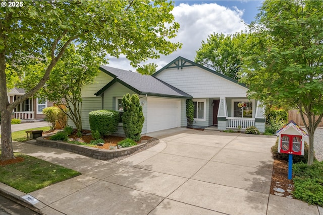 5470 Jeffrey Way, Eugene, OR 97402 - view of front of house featuring a porch, an attached garage, concrete driveway, and roof with shingles