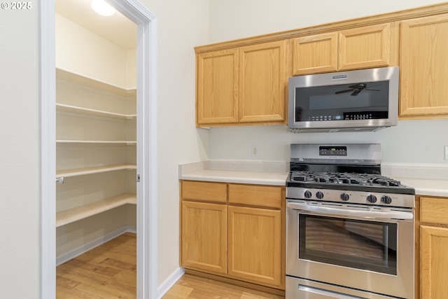 5470 Jeffrey Way, Eugene, OR 97402 - kitchen with appliances with stainless steel finishes, light wood finished floors, light countertops, and light brown cabinetry
