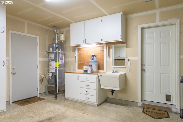 5470 Jeffrey Way, Eugene, OR 97402 - kitchen with secured water heater, a sink, white cabinets, and light countertops
