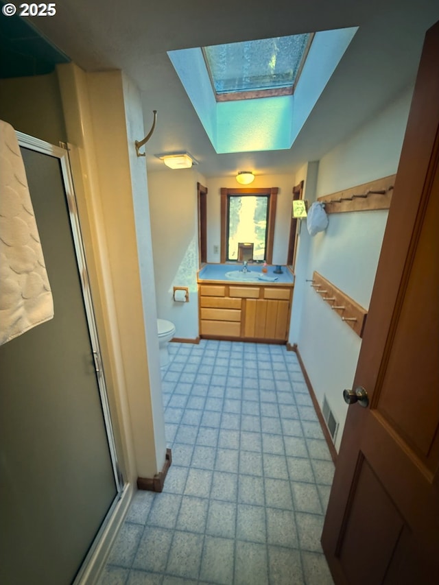 full bathroom featuring baseboards, visible vents, a skylight, and a stall shower
