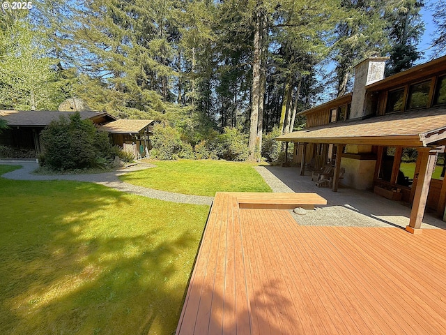 view of yard featuring a patio area and a wooden deck