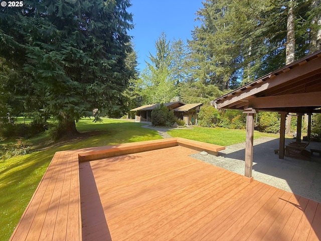 wooden deck featuring a yard and a patio