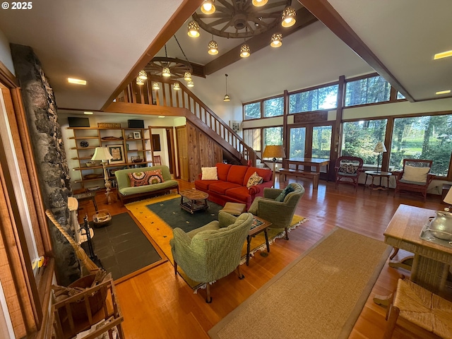 living room with ceiling fan, a wealth of natural light, and wood finished floors