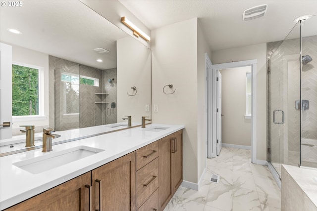 bathroom with vanity and a shower with shower door