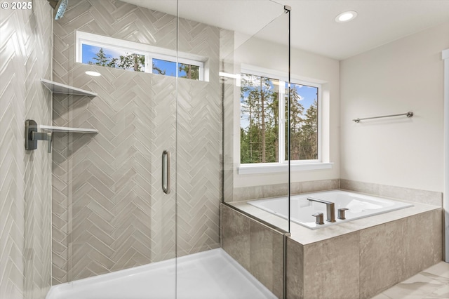 bathroom featuring separate shower and tub