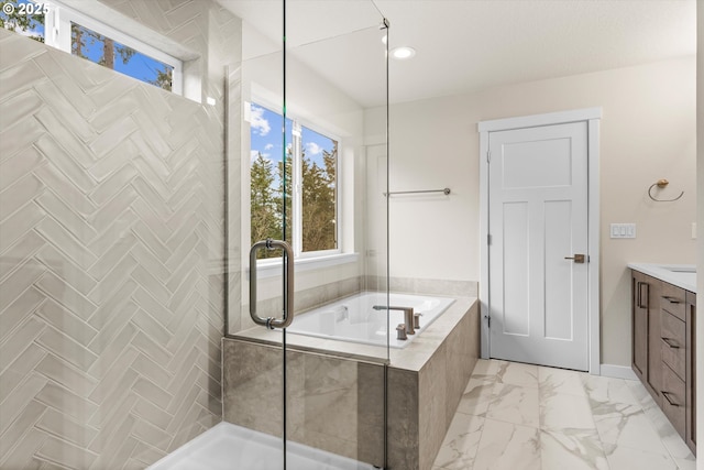 bathroom featuring shower with separate bathtub and vanity