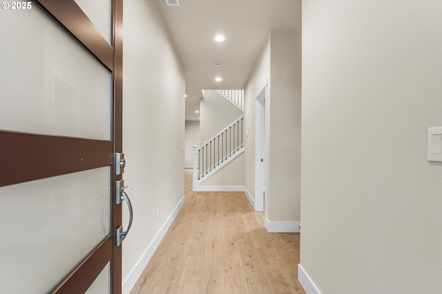 corridor with light wood-type flooring