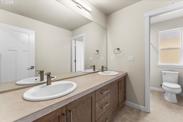 bathroom with tile patterned floors, vanity, and toilet