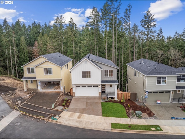 view of front of house with a garage and central AC