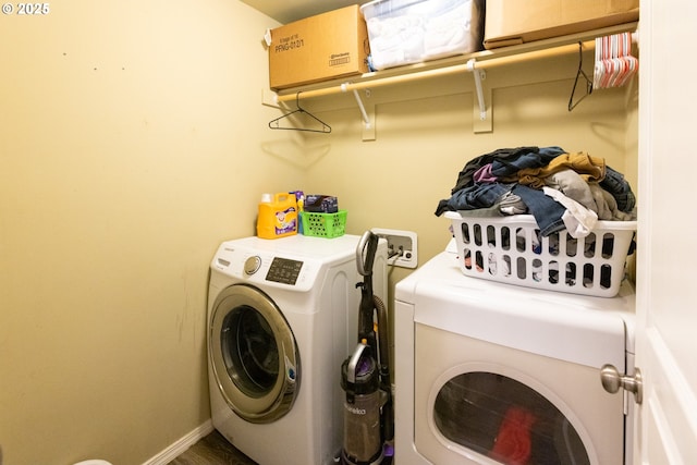 laundry room featuring laundry area, washing machine and dryer, and baseboards