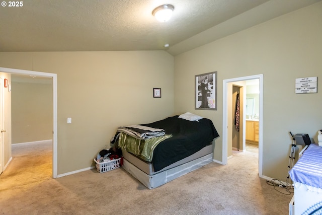 bedroom with vaulted ceiling, carpet floors, and baseboards